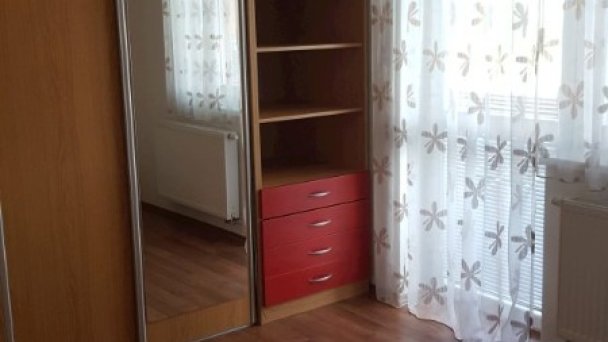 Spálňa dvojizbového apartmánu na poschodí, pohľad na vstavanú skriňu a balkónové dvere na južný balkón